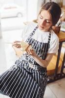 Young female ceramist indoors with handmade clay product. Conception of pottery photo