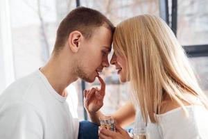 Young lovely couple together at home with champagne spending weekend and holidays together photo