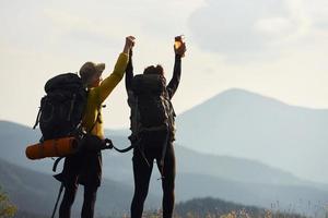 Couple conquested that hill. Majestic Carpathian Mountains. Beautiful landscape of untouched nature photo