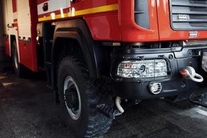 Close up view of front part of red fire truck. Natural lighting photo