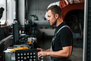 Work in progress. Man in uniform is in the auto service photo