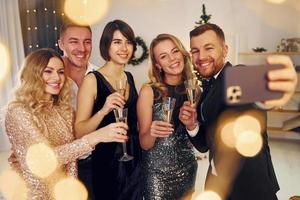Positive emotions. Group of people have a new year party indoors together photo
