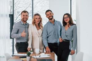 Standing together. Group of business people that working on the project in the office photo