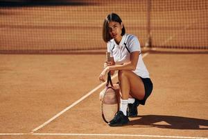 Female tennis player is on the court at daytime photo