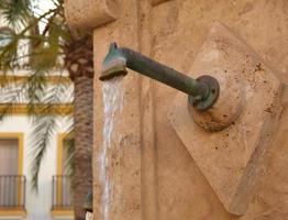 Water outlet through a pipe photo