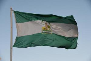 Andalusian flag with a blue sky photo