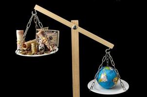 Earth and Money on a Two Pan Balance photo
