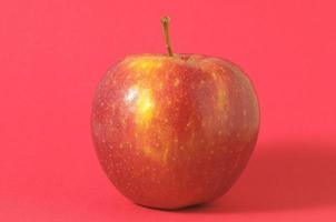 Red apple in red background photo