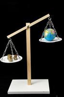 Earth and Money on a Two Pan Balance photo