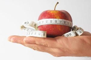 Diet Apple and Meter on the Hand photo