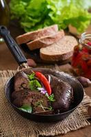 Homemade blood sausage with offal on the old wooden background in rustic style photo