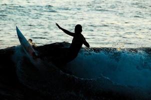 Silhouette of a surfer photo