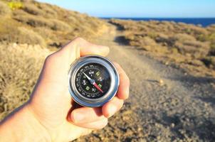 Orientation Concept with hands holding a compass photo