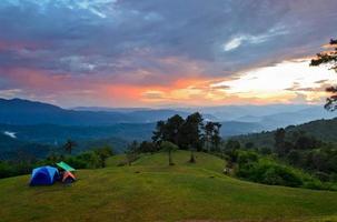 puesta de sol sobre las colinas en el camping en la alta montaña foto