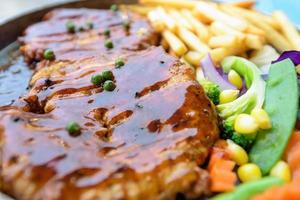 Beef steak topped with black pepper sauce photo