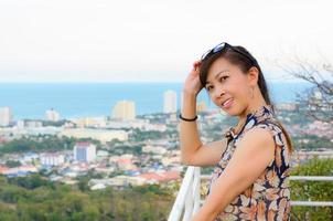 Woman poses on a high point overlooking the city. photo