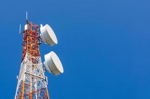 Telecommunication tower on blue sky background photo