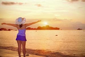 Visitors woman looking the sunrise over the sea photo