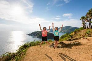 Two girls mother and daughter jumping photo