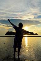 Women happy sunrise at the beach photo