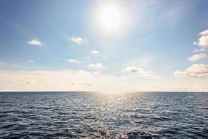 Sun on blue sky and sea in summer Thailand photo