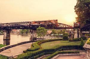 Old photo style bridge over the River Kwai