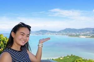 Women tourist inviting to see of the sea in Phuket Province, Thailand photo