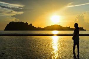 Girls on the beach during sunrise. photo