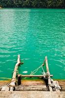 Ladder made of wood into the water photo