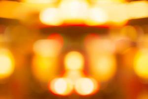 Blur gold, orange, and red color bokeh background. Blur abstract background for Christmas day. Light with a beautiful pattern of round bokeh. Orange festive light in the night. Flare lights at night. photo