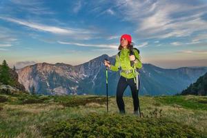 Mountain hike with poles in the first light of dawn photo