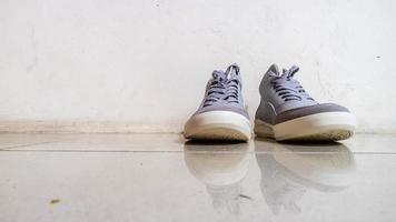 the gray sneakers on the floor photo