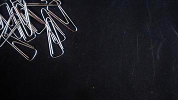 a paper clip on a black background photo