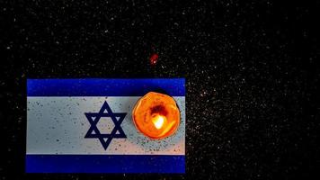 Israeli flag and candles burning above it, Holocaust memory day photo