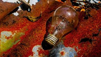 Light bulb on rusty zinc as a background photo