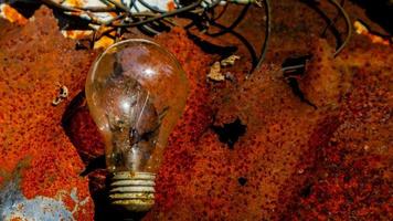 Light bulb on rusty zinc as a background photo