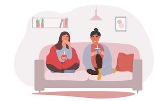 Two girls to a friend are sitting on the couch in blankets and drinking a hot drink. Women at home communicate in a cozy interior. Vector graphics.