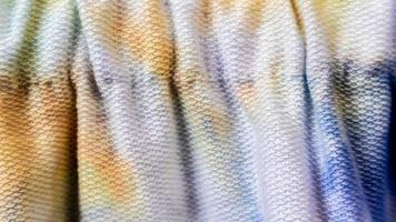 white cloth texture with yellow and blue patterns as background photo