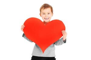 Lovely boy holding heart photo