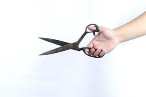 hand holding scissors isolated on white background photo