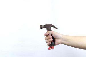 hand holding hammer isolated on white background photo