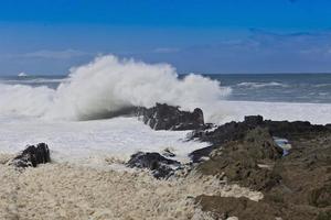 Big wave hits rocks on coast photo