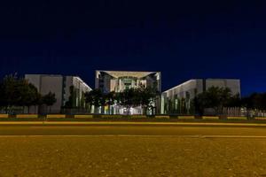 View on illuminated chancellery in Berlin at night from ground perspective photo