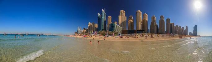 Picture of a beach in Dubai with skyline in the background photo