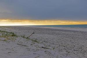 View of wide sandy beach of Lyngvik in Denmark in evening light photo