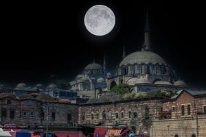 View of Ruestuem Pasha Mosque in Istanbul during night with full moon photo