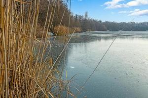 View of the ice surface of a draught frozen lake during the day photo