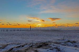 Sunset on winter beach of Balvand in Denmark photo