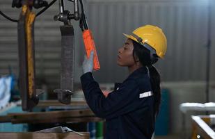 Female technicians Inspecting and testing the operation of lifting cranes photo