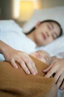 A mother must sleep and rest with her newborn baby. In the white bedroom, warm sunlight in the evening of the day. photo